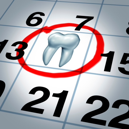 Calendar with a single tooth marking the day of a dentist appointment.