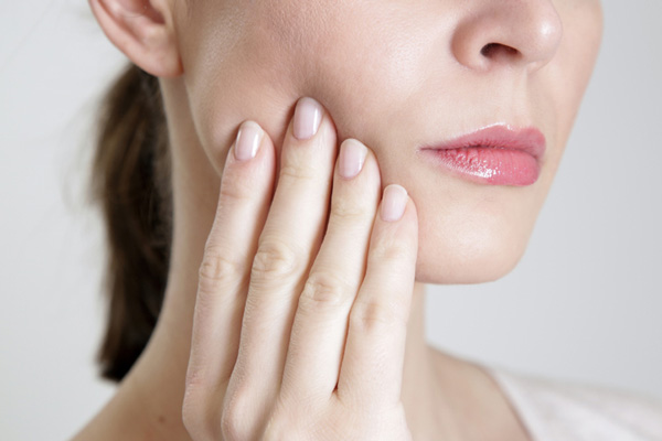 Close-up of a person with facial pain.