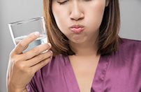 close up of woman using a salt water rinse